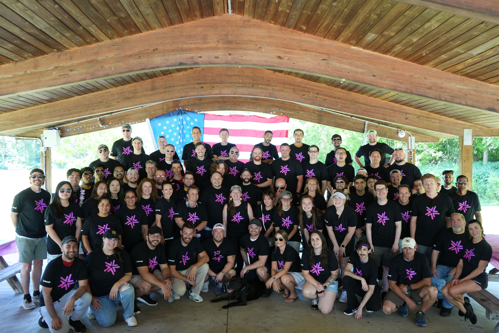 The Lynkwell team all standing together in front of an American flag under a gazebo