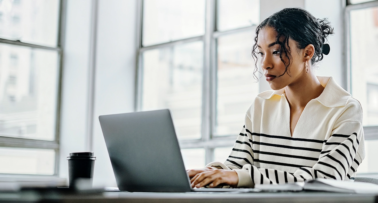 Business woman on a laptop typing out an email