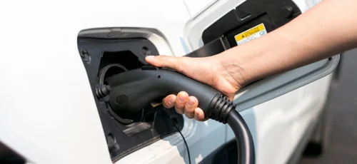 A woman charging her electric vehicle