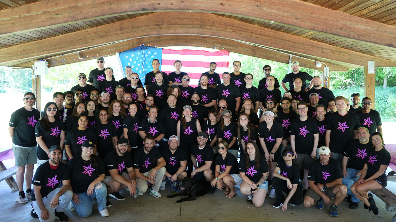 The Lynkwell team all standing together in front of an American flag under a gazebo